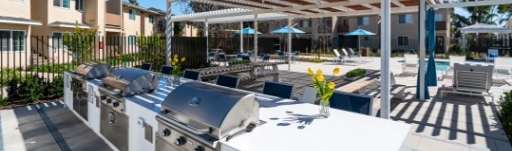community outdoor area with a dedicated grill space